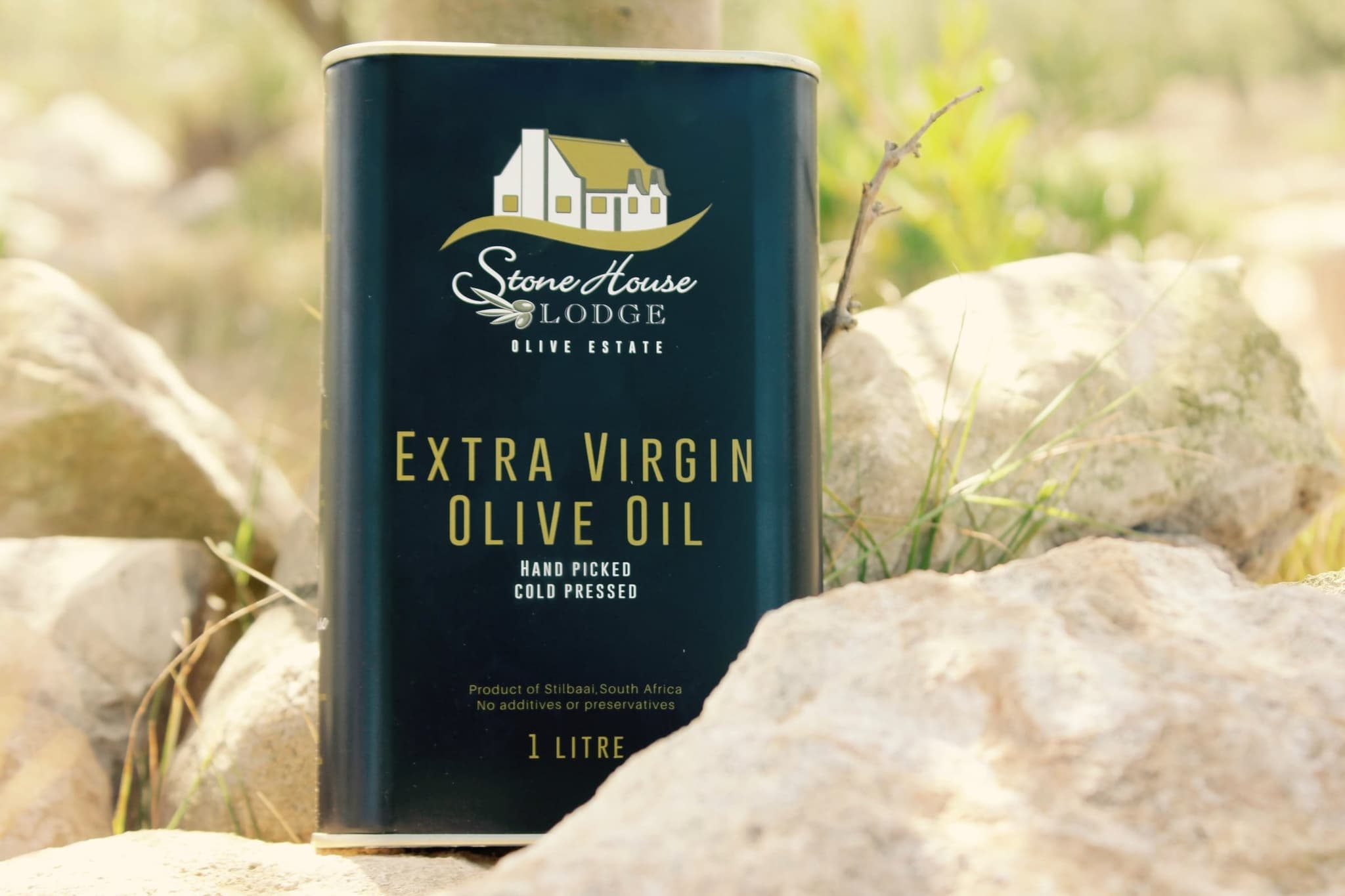 A one-litre tin of Stonehouse Lodge extra virgin olive oil, hand picked and pressed on the farm, standing on a rock.